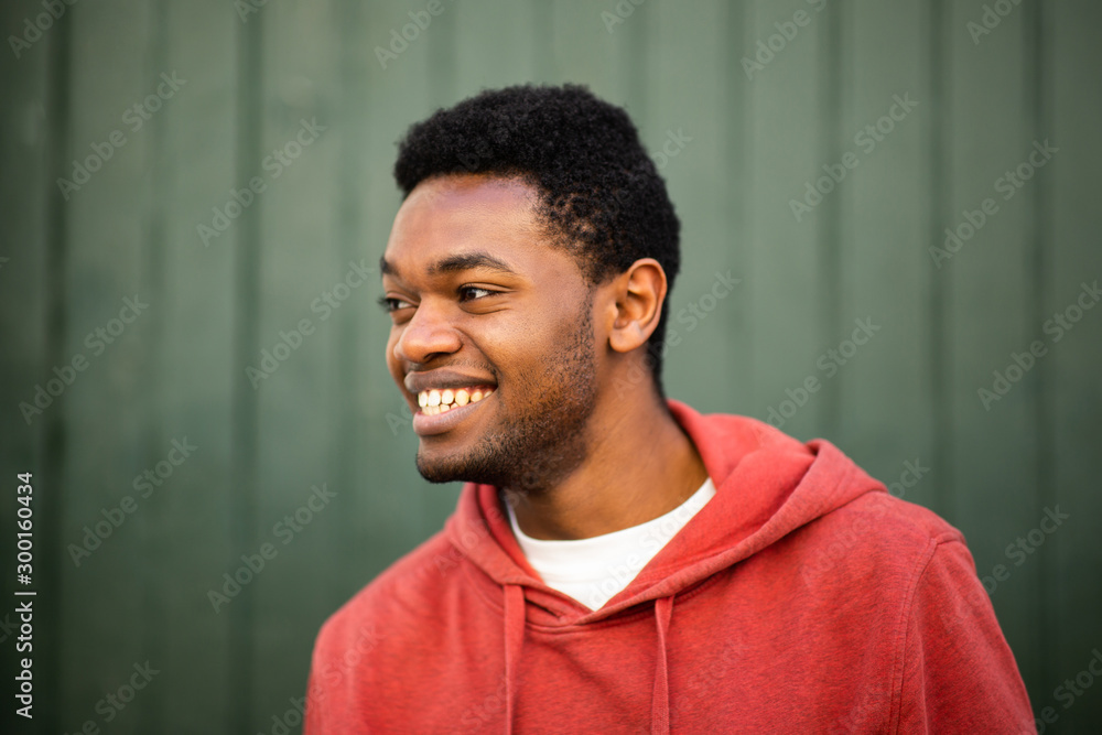 Fototapeta premium horizontal portrait of smiling young african man looking away