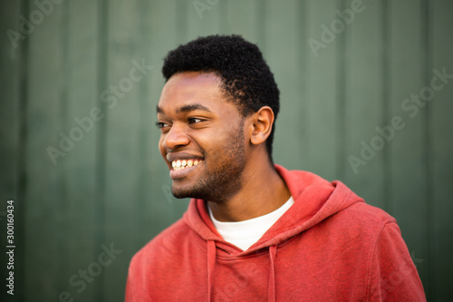 horizontal portrait of smiling young african man looking away