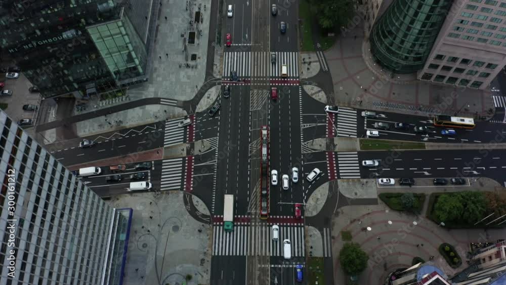 Aerial view of a city junction with skyscrapers in the daytime. Warsaw, Poland. Drone fired from top to bottom at an intersection with car traffic in the city center. Aerial view of a city junction with skyscrapers in the daytime. Warsaw, Poland. Drone fired from top to bottom at an intersection with car traffic in the city center.