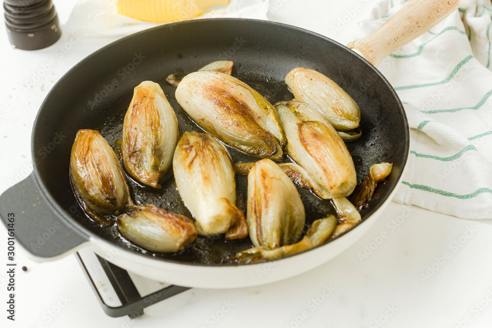 Braised chicory on the belgian way in a baking pan Braised chicory on the belgian way in a baking pan