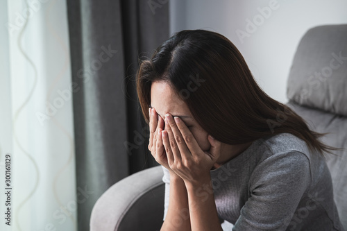 Fotografie Depressed and sadness woman crying alone at home