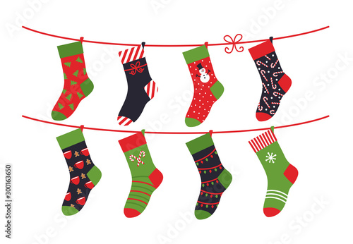 Cartoon socks. Children clothing elements with cute Christmas patterns drying sock collection on rope. Vector illustration winter holidays flat set green colour comfortable clothes