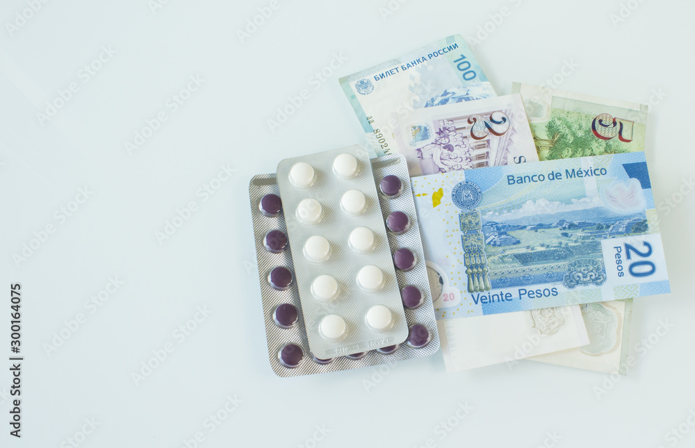 money from different countries and medicines on a light background money from different countries and medicines on a light background