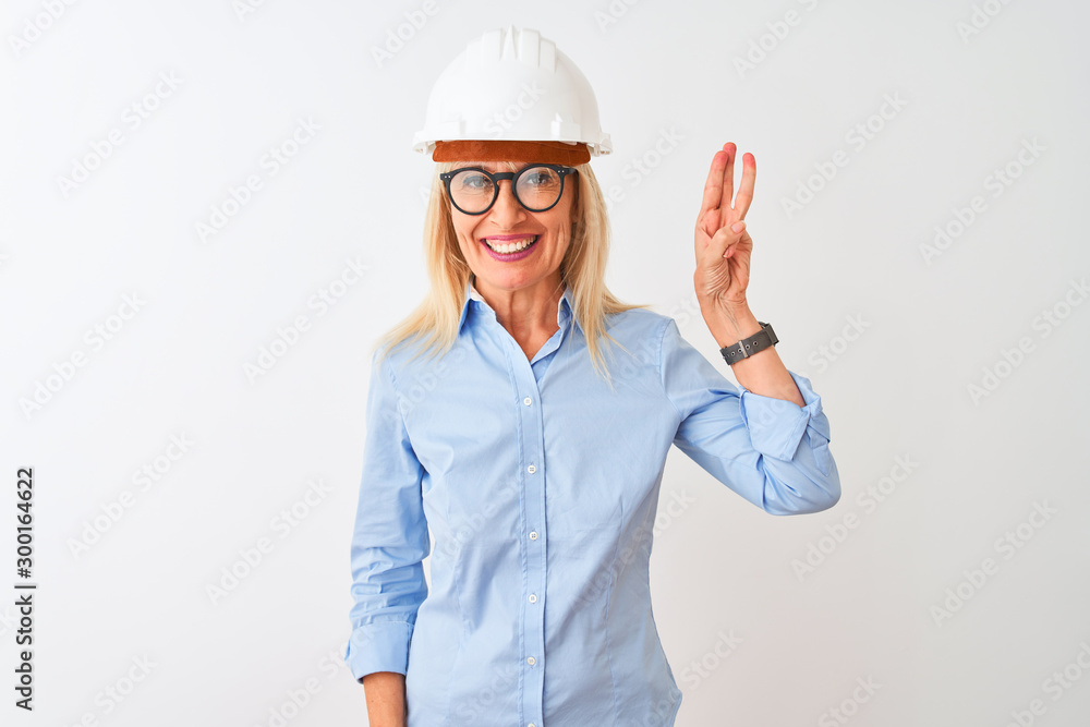 Middle age architect woman wearing glasses and helmet over isolated white background showing and pointing up with fingers number three while smiling confident and happy. Middle age architect woman wearing glasses and helmet over isolated white background showing and pointing up with fingers number three while smiling confident and happy.