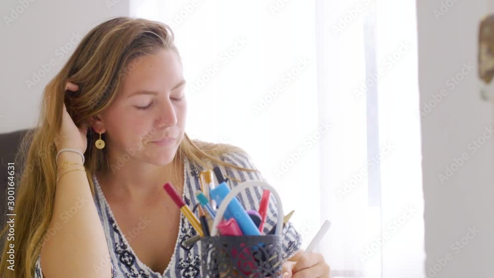 Young girl contemplating problem while doing homework, pan shot Young girl contemplating problem while doing homework, pan shot
