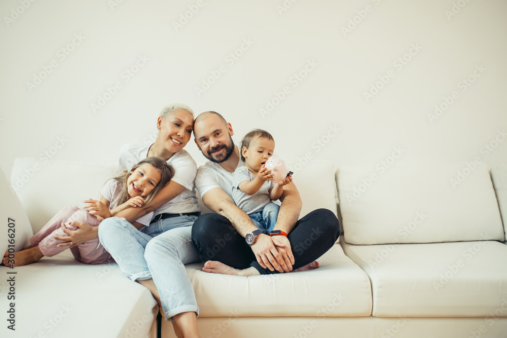 Enjoying family relax at home, Portrait of beautiful caucasian family sitting on sofa. Family, children concept. White colors Enjoying family relax at home, Portrait of beautiful caucasian family sitting on sofa. Family, children concept. White colors