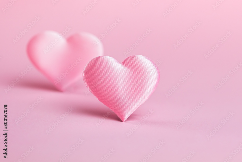 Pink silk heart on a pink background. The concept of minimalism. Place for text. Pastel colors .