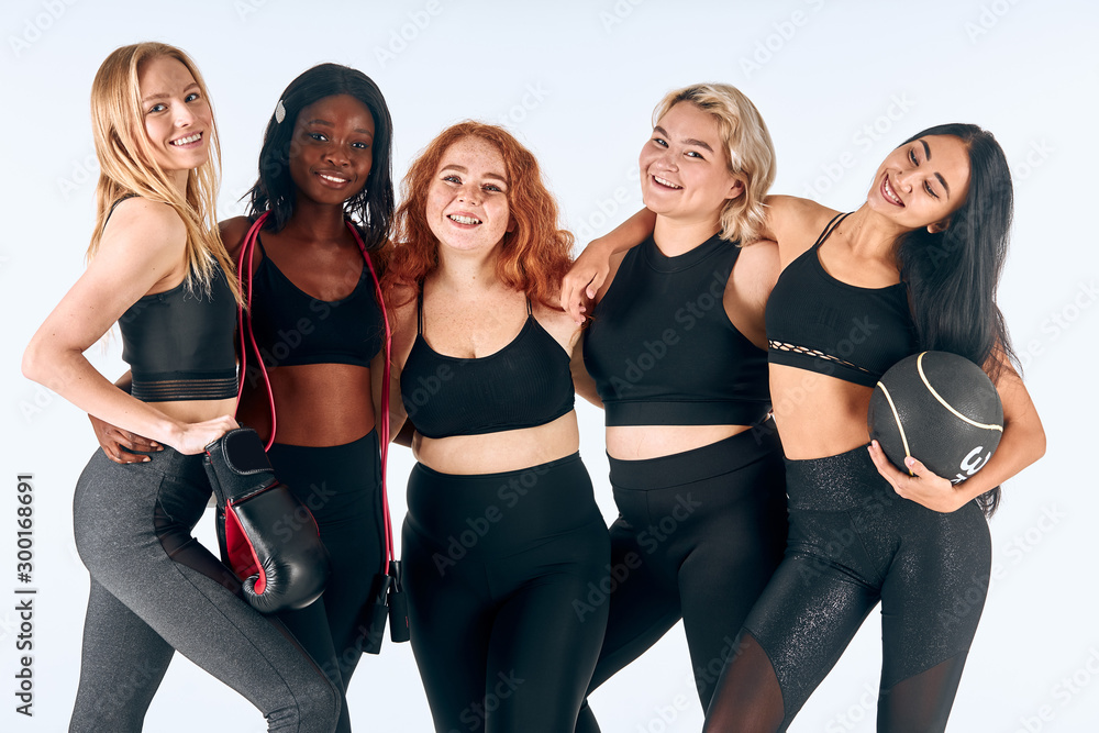 Portrait of young sportive girls together, different appearances. People relationships Portrait of young sportive girls together, different appearances. People relationships