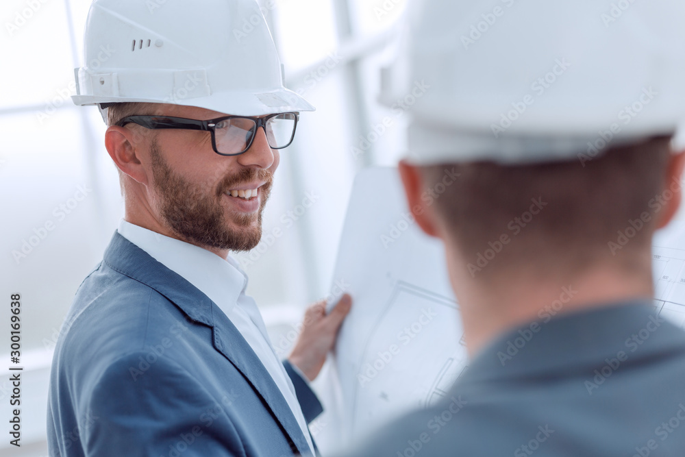 close up. architect and engineer discussing blueprints of a new project close up. architect and engineer discussing blueprints of a new project