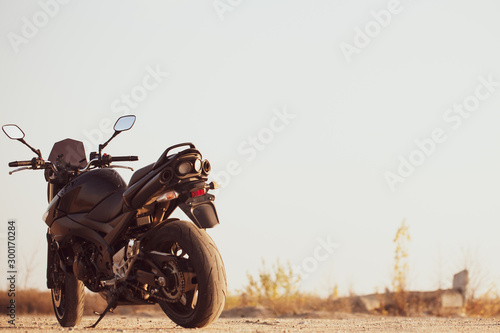 One black motorcycle in the desert. photo