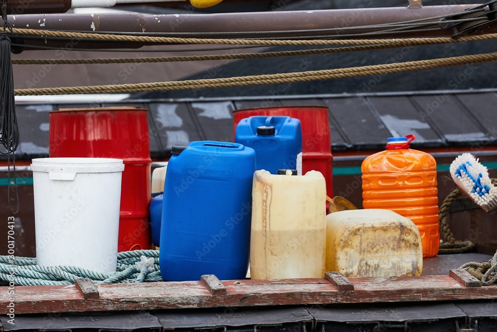 Various plastic cans with chemicals and fuel in a ship harbor Various plastic cans with chemicals and fuel in a ship harbor