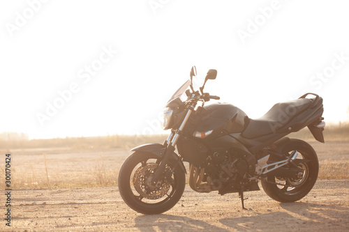 One black motorcycle in the desert.