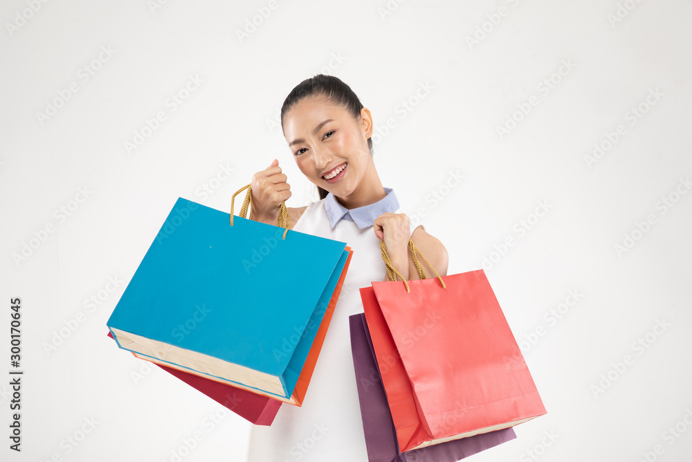 Shopping Asian woman smile and Holding Shopping bags,Cheerful and happiness emotional,Enjoy Shopping in black friday sale,Isolated on gray background,Shopping Concept Shopping Asian woman smile and Holding Shopping bags,Cheerful and happiness emotional,Enjoy Shopping in black friday sale,Isolated on gray background,Shopping Concept