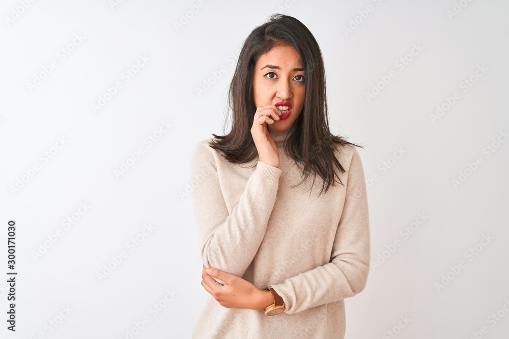 Beautiful chinese woman wearing turtleneck sweater standing over isolated white background looking stressed and nervous with hands on mouth biting nails. Anxiety problem. Beautiful chinese woman wearing turtleneck sweater standing over isolated white background looking stressed and nervous with hands on mouth biting nails. Anxiety problem.