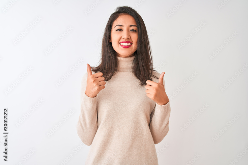 Beautiful chinese woman wearing turtleneck sweater standing over isolated white background success sign doing positive gesture with hand, thumbs up smiling and happy. Cheerful expression Beautiful chinese woman wearing turtleneck sweater standing over isolated white background success sign doing positive gesture with hand, thumbs up smiling and happy. Cheerful expression