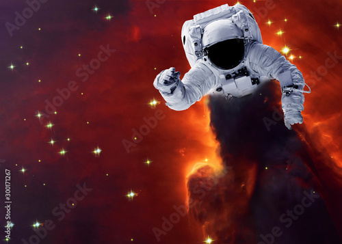 Astronaut Somewhere in extreme deep space far galaxies and stardust. Science fiction wallpaper. Elements of this image were furnished by NASA.