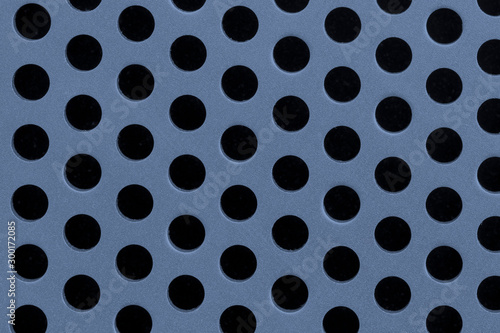 Metal grid texture with holes close-up, blue steel surface, modern background