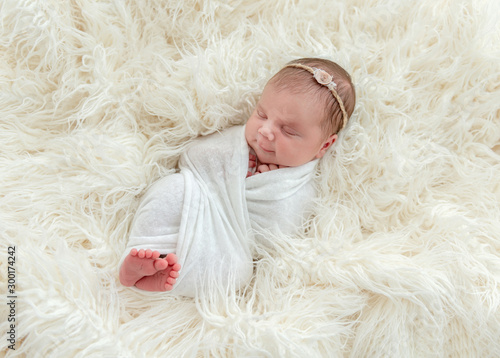 newborn baby sleeping on a little pillow