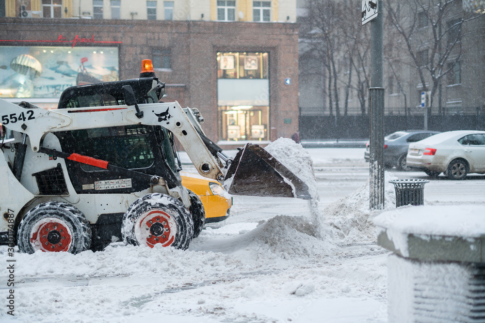 the city snow cleaning service department at work in the public streets, cold season the city snow cleaning service department at work in the public streets, cold season