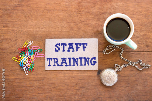 Writing note showing Staff Training. Business concept