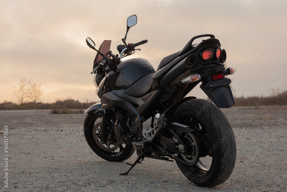 One black motorcycle in the desert.