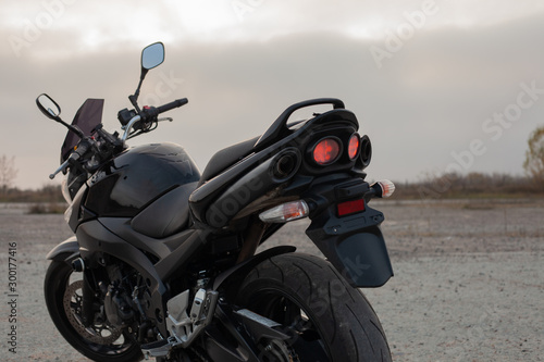 One black motorcycle in the desert.