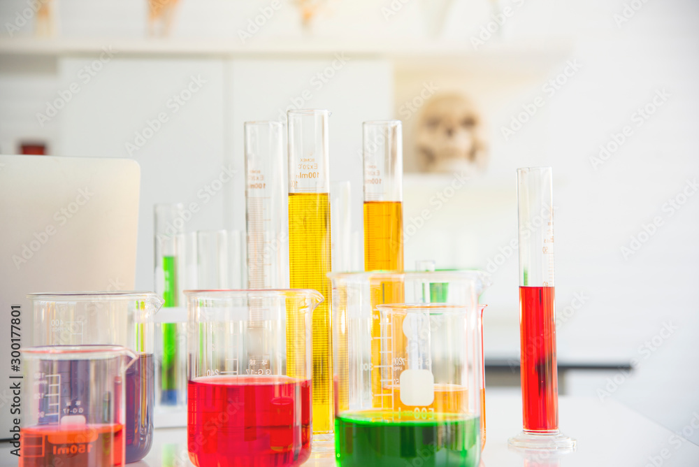 Several test tubes and solution beakers in a science laboratory with liquid of different colors on the laboratory table for chemical background Several test tubes and solution beakers in a science laboratory with liquid of different colors on the laboratory table for chemical background