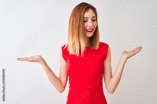 Wallpaper Mural Redhead businesswoman wearing elegant red dress standing over isolated white background smiling showing both hands open palms, presenting and advertising comparison and balance Torontodigital.ca