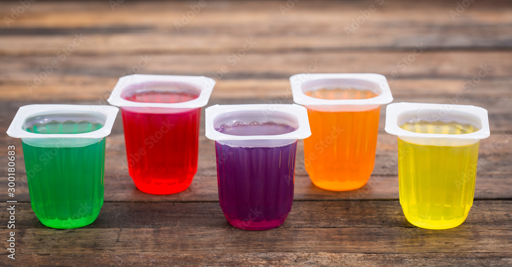Multi Coloured fruit jelly in the plastic cups Multi Coloured fruit jelly in the plastic cups