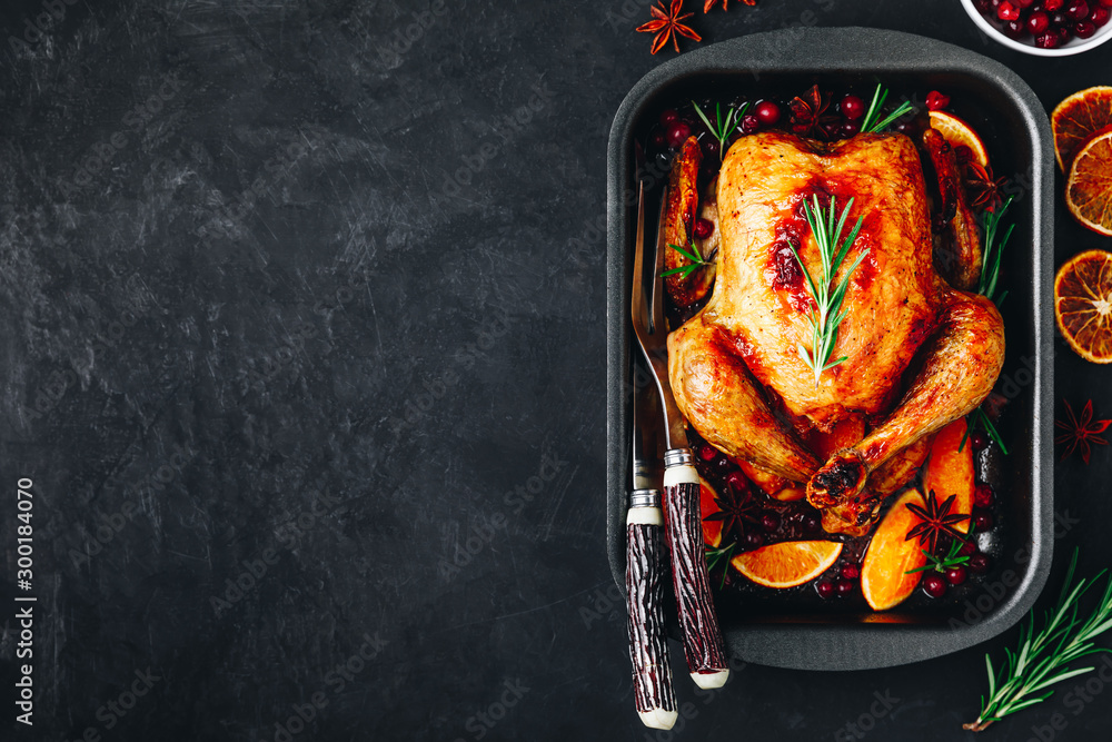 Roasted chicken or turkey with spices, oranges and cranberries for Christmas or Thanksgiving - obrazy, fototapety, plakaty 