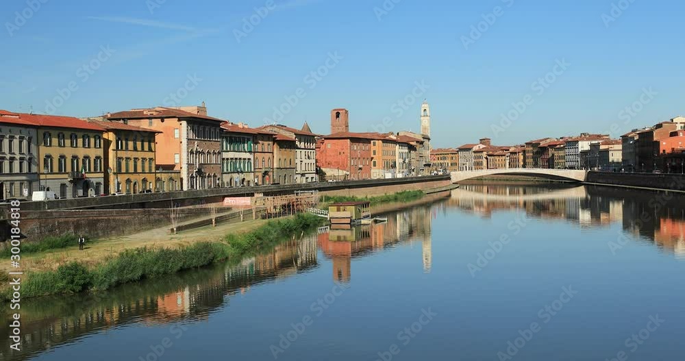 The bridge Ponte Di Mezzo over the Arno River in autumn. A view of historical center. Amazing reflection of the buildings and the bridge in river Arno. Pisa, Tuscany region, Italy The bridge Ponte Di Mezzo over the Arno River in autumn. A view of historical center. Amazing reflection of the buildings and the bridge in river Arno. Pisa, Tuscany region, Italy