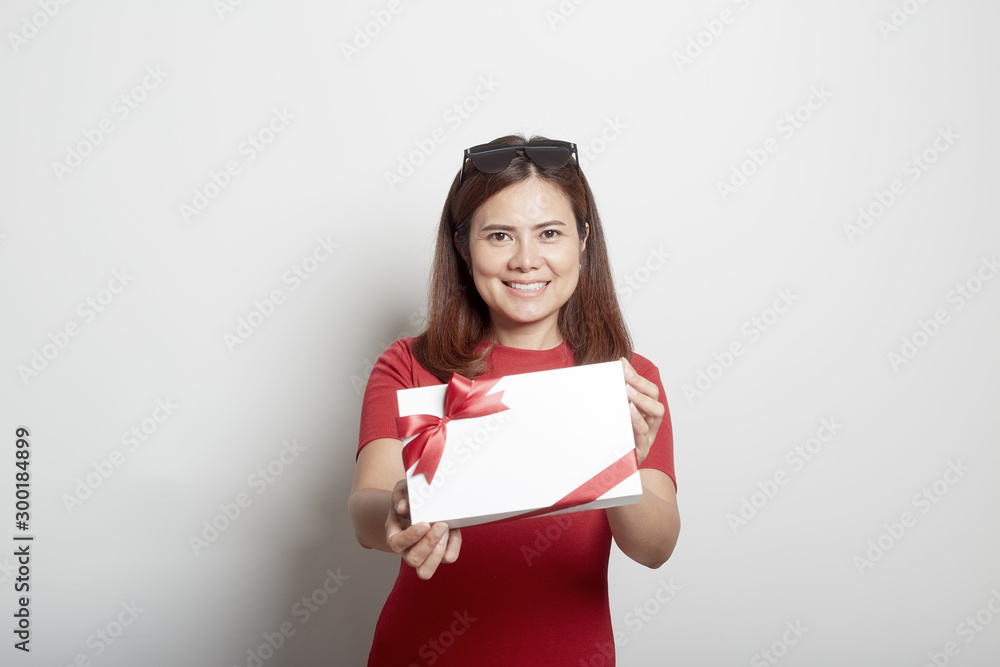 Happy young girl holding a christmas gift Happy young girl holding a christmas gift