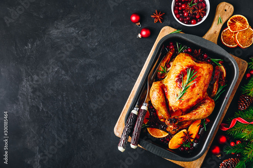 Tableau sur Toile Christmas baked chicken or turkey with spices, oranges and cranberries