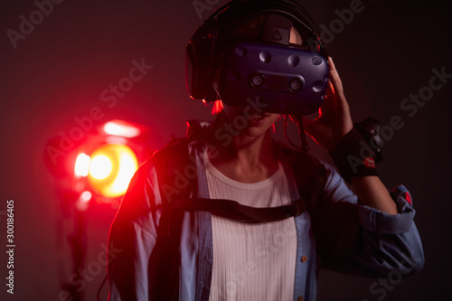 Girl with glasses of virtual reality on head. Virtual reality, science, future technology, fantastic, robots and people concept. Neon backlit © alfa27