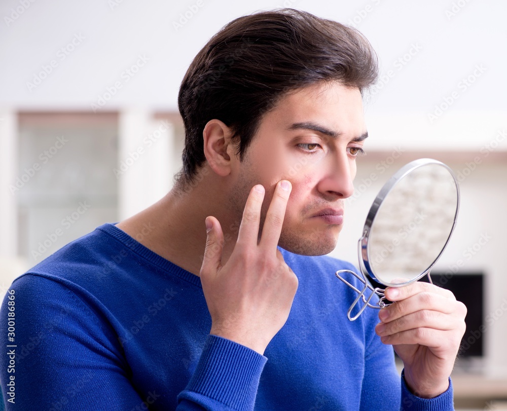 Man panicking because of pimples on the skin Man panicking because of pimples on the skin