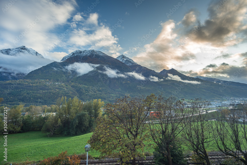 Fototapeta premium mountain panorama with first snowfall, clouds and fog