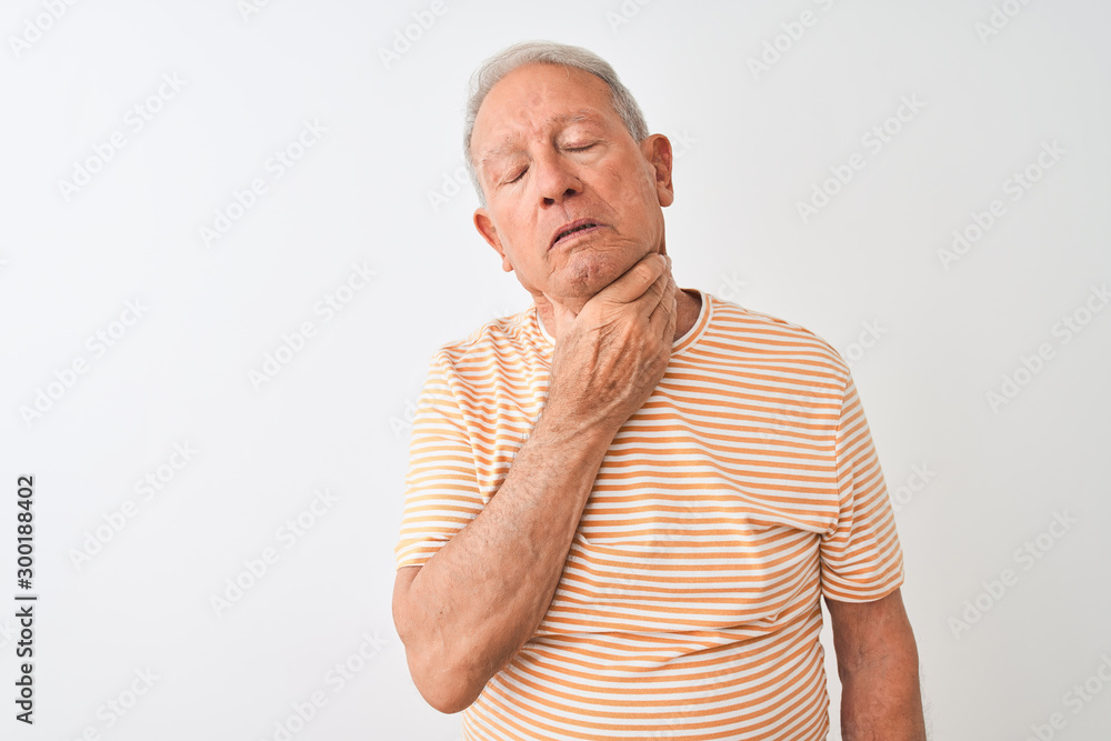 Senior grey-haired man wearing striped t-shirt standing over isolated white background Touching painful neck, sore throat for flu, clod and infection Senior grey-haired man wearing striped t-shirt standing over isolated white background Touching painful neck, sore throat for flu, clod and infection