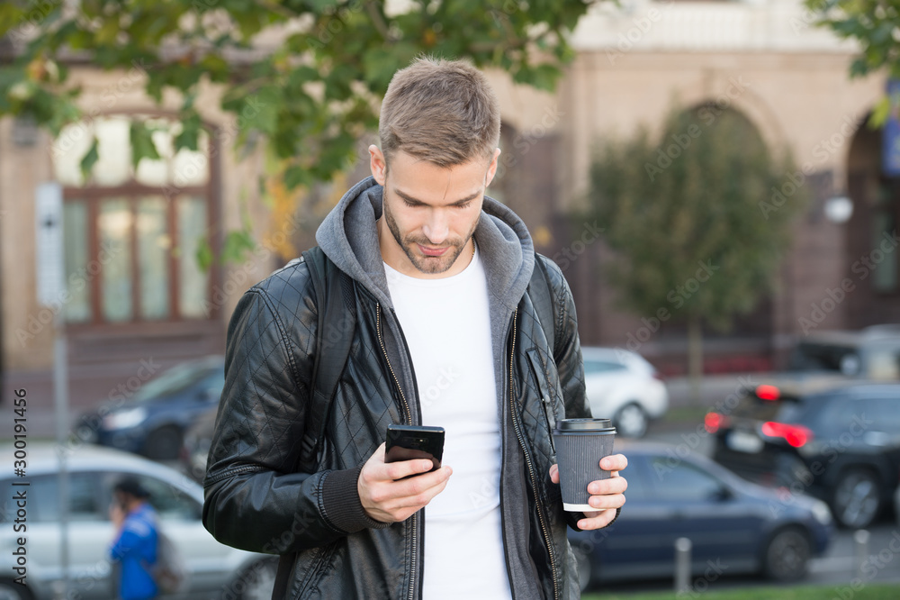 Coffee time anytime. Handsome man hold smartphone and coffee cup. Takeaway coffee. Young businessman drink coffee to go. Mobile lifestyle. Modern life. New technology Coffee time anytime. Handsome man hold smartphone and coffee cup. Takeaway coffee. Young businessman drink coffee to go. Mobile lifestyle. Modern life. New technology