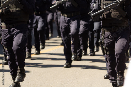 close up of the special weapon and assault officers during a parade holding their assault guns
