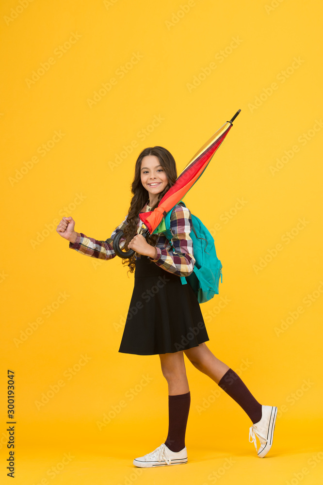 Only happy when it rains. Happy girl go to school. Little girl carry stick umbrella for rainy weather. Small girl wear school dress and backpack. Girl child education. Back to school in any weather Only happy when it rains. Happy girl go to school. Little girl carry stick umbrella for rainy weather. Small girl wear school dress and backpack. Girl child education. Back to school in any weather