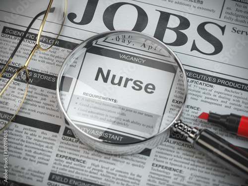Nurse vacancy in the ad of job search newspaper with loupe.