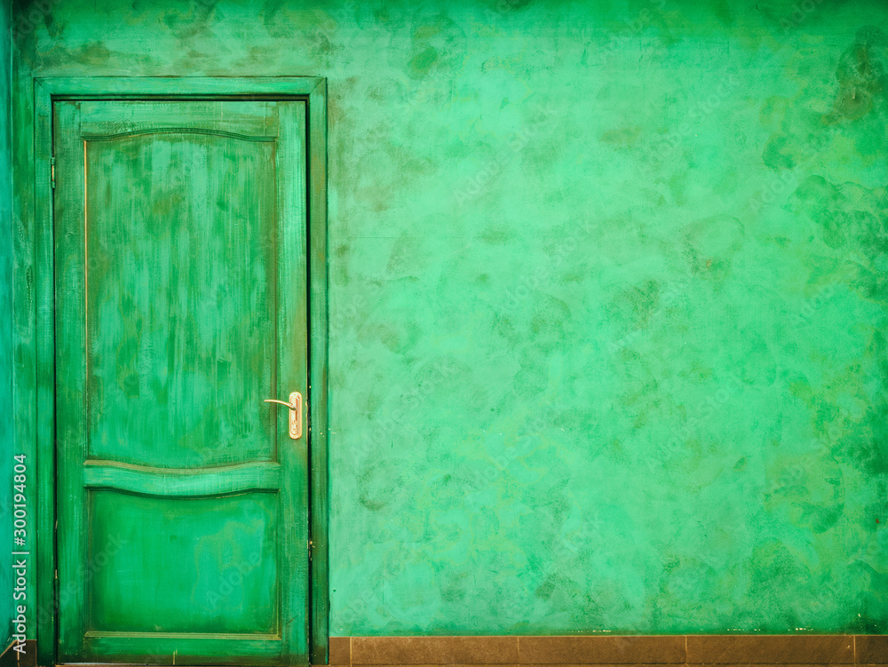 Abstract background, wooden door and wall painted with dirty green paint