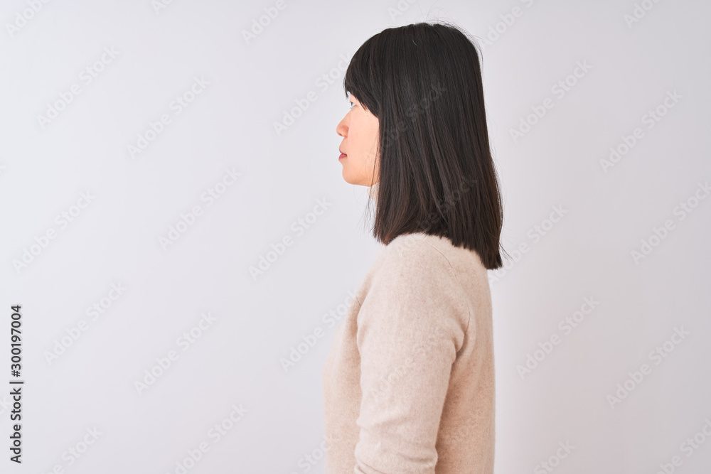 Young beautiful chinese woman wearing turtleneck sweater over isolated white background looking to side, relax profile pose with natural face with confident smile. Young beautiful chinese woman wearing turtleneck sweater over isolated white background looking to side, relax profile pose with natural face with confident smile.