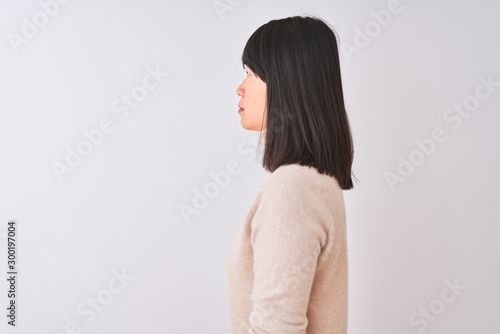Young beautiful chinese woman wearing turtleneck sweater over isolated white background looking to side, relax profile pose with natural face with confident smile.
