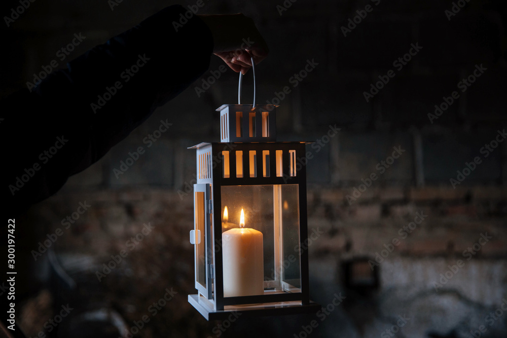 Woman holding lantern with candle in old abandoned house. A lantern  illuminates the way. Creepy scary concept. Halloween night. Ghost town.  Burning candle in scary deep night. Stock Photo | Adobe Stock