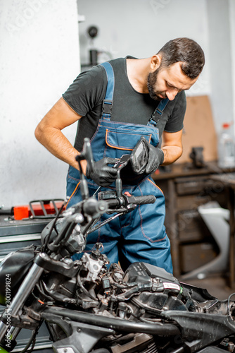 Mechanic repairing or tuning motorcycle