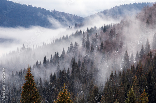 Beautiful rising fog in winter mountain landscape.