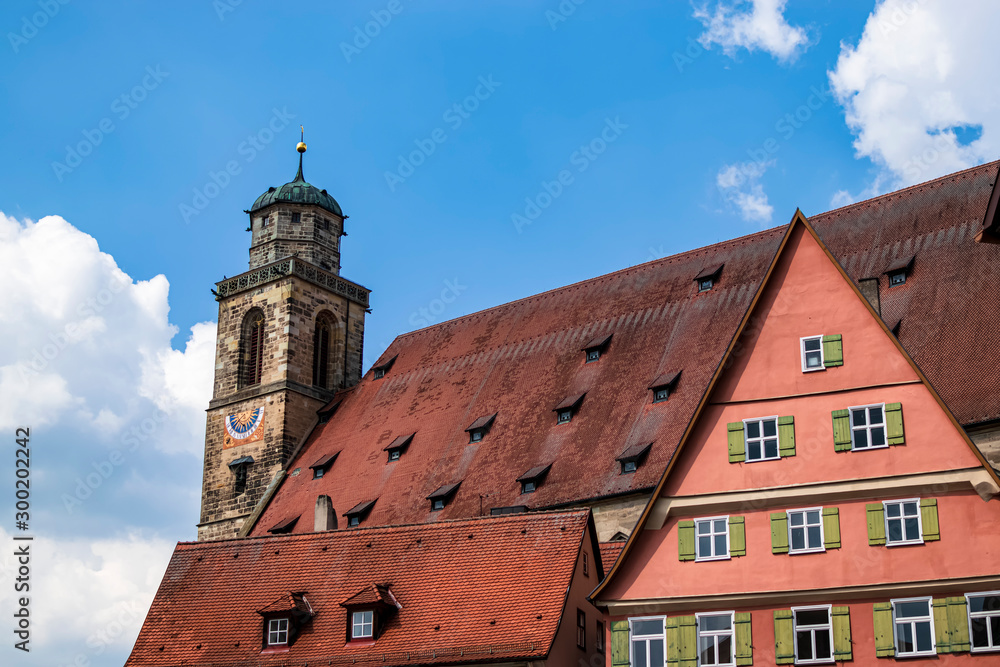 Detail of the bell tower as well as its roof and part of the facade of the Church of Münster St. Georg Dinkelsbühl. Photography taken in Dinkelsbühl, Bavaria, Germany.