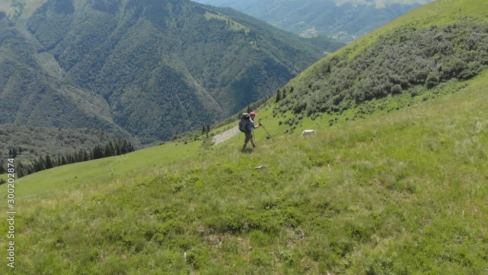 Aerial flight above people hiking along trail path. Two friends summer adventure journey in mountain nature outdoors. 4k drone shot. Aerial flight above people hiking along trail path. Two friends summer adventure journey in mountain nature outdoors. 4k drone shot.