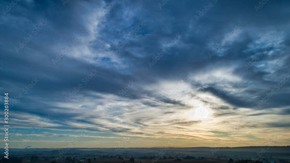 Aerial View of a Late Afternoon Sun With Partly Cloudy Blue Sky Over Farm Countryside Background Aerial View of a Late Afternoon Sun With Partly Cloudy Blue Sky Over Farm Countryside Background